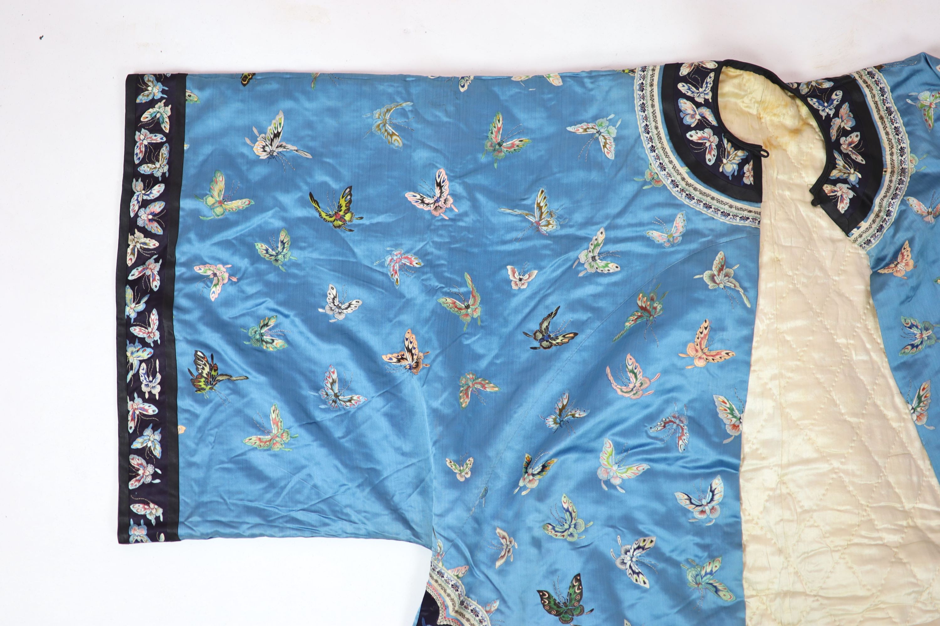 A Chinese blue silk ‘butterfly’ Winter robe, late 19th century, 132cm drop
